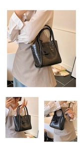 Three-way view of a black crocodile-embossed bucket bag with elephant charm and strap