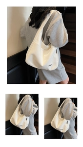 Detail of a large white Hobo tote bag featuring a Merrey logo patch for daily use