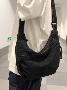 Minimalist black denim crescent crossbody bag with white stitching and pockets