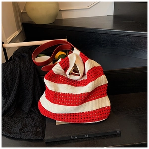 Close-up of red and white striped woven tote bag with premium leather shoulder strap
