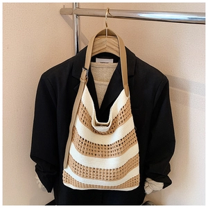 Close-up of contrast woven tote bag showing crochet hollow pattern and leather strap