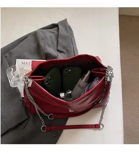 Interior view showing large capacity of red leather chain bag with daily essentials