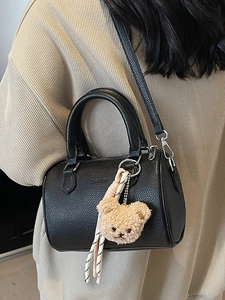Classic black litchi textured Boston bag with bear charm and adjustable shoulder strap