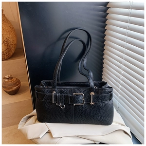 Detail showing black lychee grain leather texture with silver buckle and metal ring decor