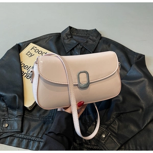 Detail of light pink PU leather bag featuring elegant oval metal buckle and fine texture
