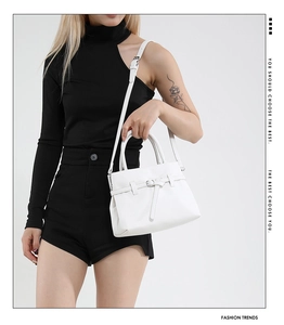 Chic white lychee grain leather square bag with buckle detail on a modern model