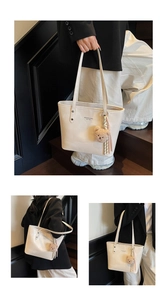 Detail of off-white tote bag with logo print and cute plush bear keychain charm accessory