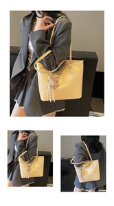 Close-up of cream tote bag featuring matte PU leather and a brown plush bear charm