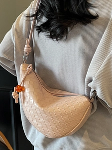 Chic pink woven crescent crossbody bag with adjustable knotted strap and amber bead