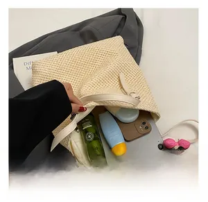 Spacious interior of beige woven tote bag showing storage for tablet and essentials