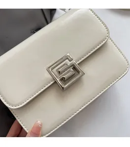 Detailed close-up of cream PU leather crossbody bag featuring a silver geometric metal lock