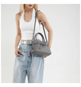 Detail of dark grey litchi grain leather handbag with detachable shoulder strap for women