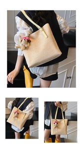 Close-up of handwoven tote bag with yellow leather strap and cute dog plush charm