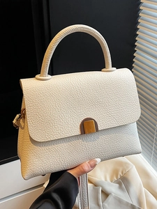 Minimalist cream white crossbody bag in litchi grain leather with metal lock detail