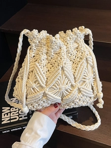 Minimalist hand-woven bucket bag with geometric knit pattern and wooden bead detail