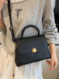 Minimalist black lychee texture leather handbag with gold hardware and shoulder strap