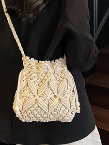 Handmade bohemian ivory woven straw bucket bag with macrame pattern and wood bead drawstring