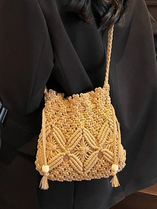 Handmade woven crossbody bucket bag with bohemian fringe and wooden bead accents