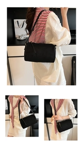 Minimalist black rectangular shoulder bag in premium matte leather with slim fixed straps