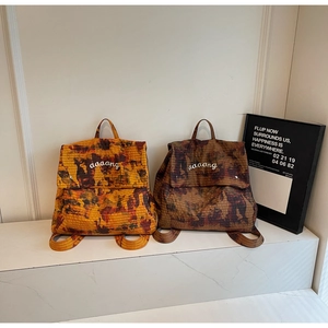 Detail showing camouflage textured mesh fabric on yellow and brown backpacks