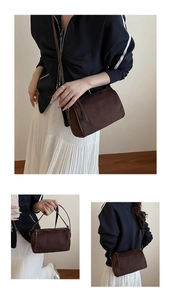 Detailed views of a dark brown suede cylinder bag with tassel zipper and slim shoulder strap