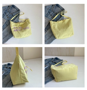 Detailed four-way view of light yellow tote bag with purple Paris embroidery and drawstring