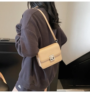 Model view showing the beige minimalist square crossbody bag with silver buckle detail