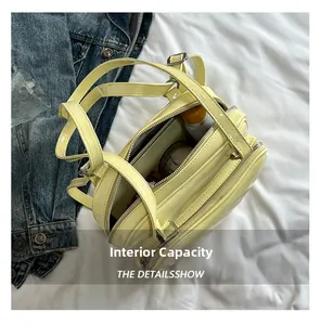 Detail view of the interior space of the light yellow glossy leather bag with essentials