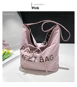 Detailed close-up of pink tote bag showing ribbon bow tie and checkered lining fabric