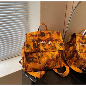 Detail shot of orange camouflage backpack with reinforced ripstop fabric and embroidery