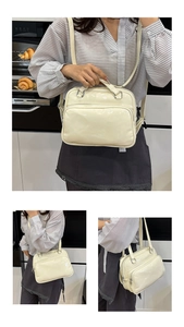 Detail view of cream white oily leather handbag with silver hardware and adjustable straps