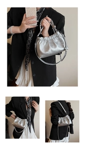 Detail of silver metallic pleated cloud bag with elegant chain and leather strap