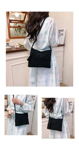 Detail of bohemian black crochet crossbody bag with woven texture and long tassel fringe