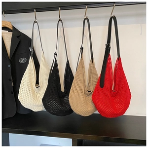Detail view of four crochet crescent bags in beige, black, brown, and red with leather straps