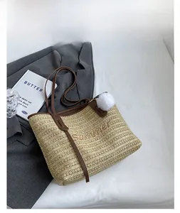 Large straw tote bag with Summer embroidery and brown leather straps on white fabric