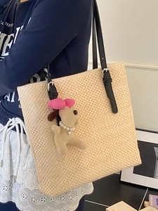 Large capacity straw tote bag with black shoulder strap and cute puppy charm for beach