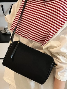 Minimalist black faux suede crossbody camera bag with adjustable strap and zipper closure