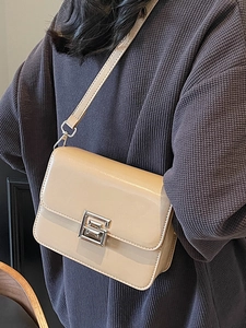 Minimalist beige crossbody square bag with silver lock and smooth leather texture