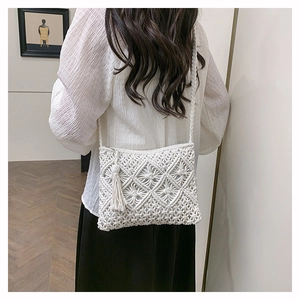 Detail of handmade macramé cotton rope bag with tassel and bohemian woven pattern