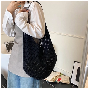 Detail view of the black crochet mesh shoulder bag showing intricate woven texture