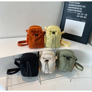 Variety of drawstring nylon crossbody bags in five colors with brand embroidery