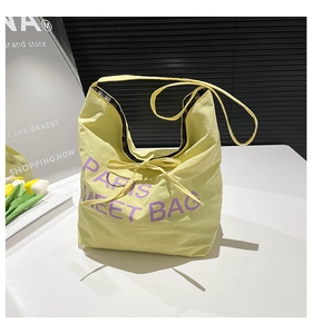 Close-up of yellow tote bag with purple Paris lettering and FF pattern lining detail