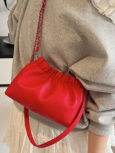 Chic bright red pleated crossbody bag with lychee texture and woven metal chain strap