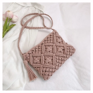 Detail of handmade cotton rope crossbody bag with tassel and bohemian woven pattern
