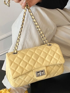 Chic quilted crossbody bag in light yellow with chain strap and silver twist lock