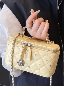 Beige quilted crossbody bag with rhinestone rivets and camellia pendant for women