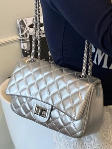 Chic silver quilted chain crossbody bag for women with metallic finish shown on model