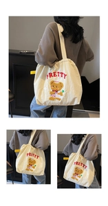 Detailed view of cream canvas tote bag with cute bear embroidery and red Pretty text