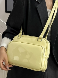 Chic pale yellow oil-wax leather handbag for women featuring high-gloss finish and dual straps
