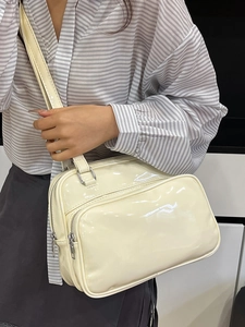 Chic creamy white oil wax leather handbag with double front pockets and wide shoulder strap
